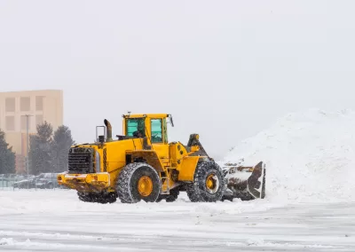 snowy weather tractor removes snow cold white